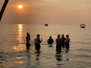 Kinetic Edge team members in Tanzania swimming in lake