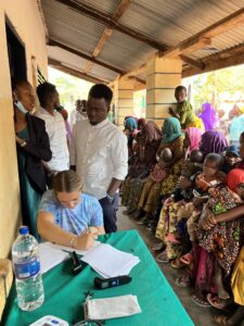 Rachael helping check in Tanzania patients